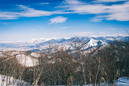 white snow and beautiful landscape during winter season in Japan against blue sky backgroundの写真素材