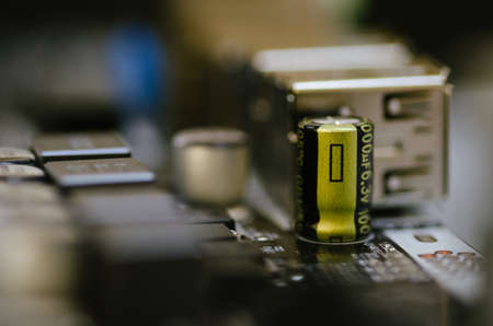 Closeup shot image of electronic circuit board. Shallow depth of field and selective focus. noise and grain due low lightの写真素材