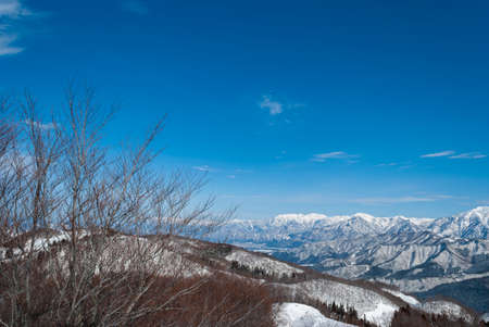 view from top mountain, white snow and beautiful landscape during winter season in Japan against blue sky backgroundの写真素材