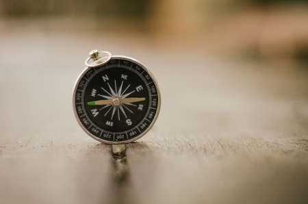 compass on wooden background for travel or direction concept.copy space for text.selective focus shotの写真素材
