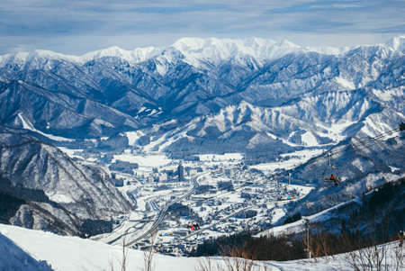 view from top mountain, white snow and beautiful landscape during winter season in Japan against blue sky backgroundの写真素材