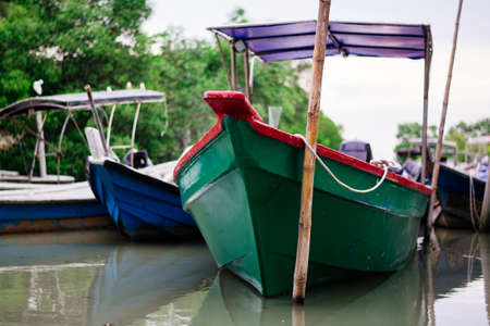 Beautiful view at Traditional fishing village with lovely sky and fishing boat moored near the shoreの写真素材