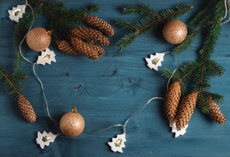 Christmas background with Christmas tree branches and cones and golden balls. Top view, frame for copy spaceの写真素材