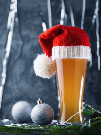 Christmas or new year beer in a hat in a festive atmosphereの写真素材