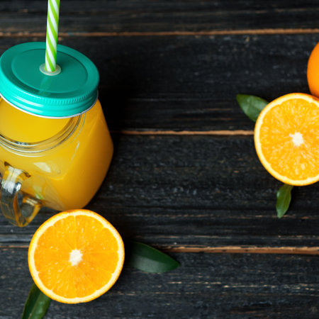 Fresh cold orange juice on wooden dark background with copyspaceの写真素材