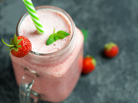 Healthy strawberry smoothie cocktail in a glass jarの写真素材