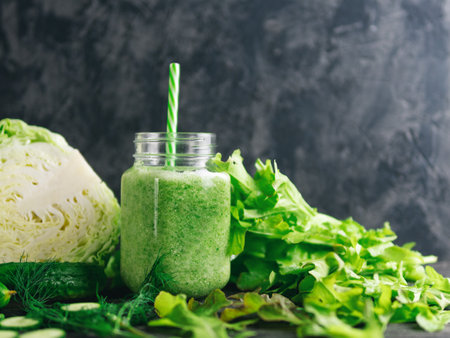 Green diet smoothie for weight loss with cabbage, cucumber, lettuce on the table, copy spaceの写真素材