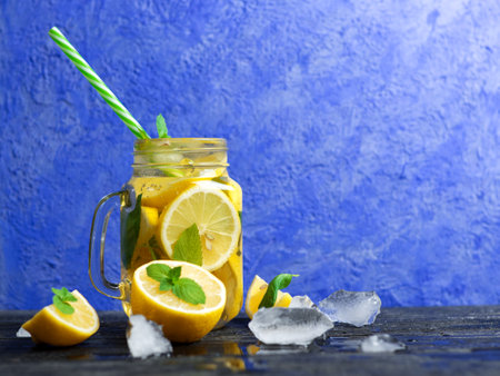 Lemonade in a glass jar with lemon, mint and ice. Mojito in glassの写真素材