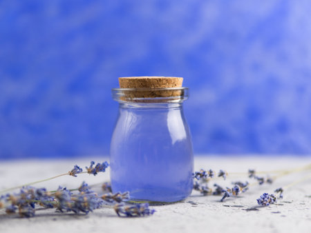 Lavender oil on blue backgroundの写真素材