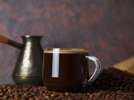 Turkish espresso coffee in a glass Cup on the table with coffee beansの写真素材