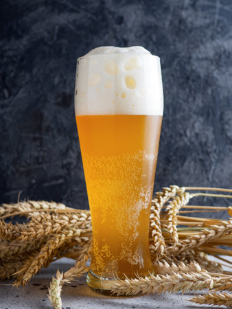 A glass of wheat beer with a foam capの写真素材
