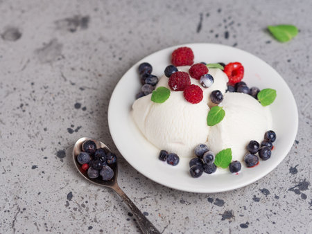 Vanilla ice cream sundae with fresh summer berriesの写真素材
