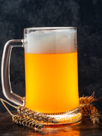 A glass of light beer on a dark background closeupの写真素材