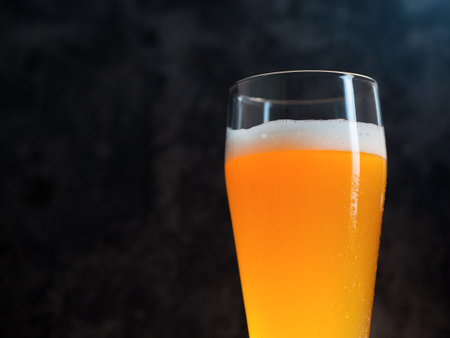 A glass of wheat beer on a dark background close-up with copyspaceの写真素材