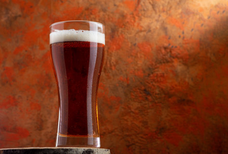 A glass of beer red ale   on a concrete backgroundの写真素材