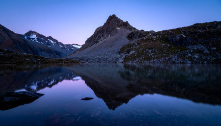 Mountains reflected in a mountain lake at sunrise. Beautiful natural landscape.の素材