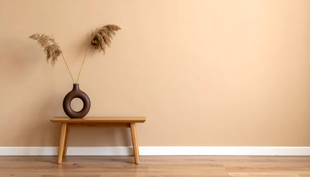 Modern, minimalist interior design shot featuring a low wooden table, a dark brown vase, and dried pampas grassの素材