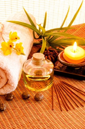 Essential oil bottles, towels, candle and flower in health spa for spa treatment の写真素材