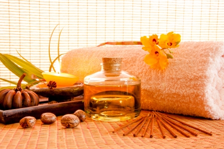 Essential oil bottles, towels, candle and flower in health spa for spa treatment の写真素材