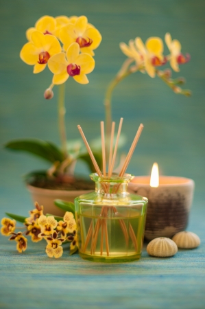 Bottle of fragrance reeds diffuser, orchid flower and candle の写真素材