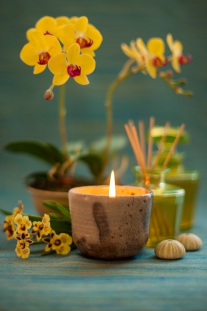Candle with orchid flower in relaxing spa scene の写真素材