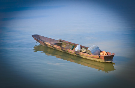 unused boat on the riverの写真素材