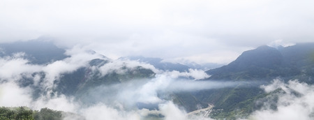 white clouds with green mountain