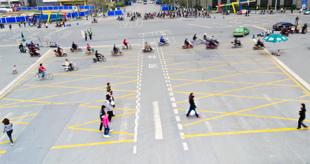 people crossing the busy street at chengdu,china.Photo is taken on 3th April 2011.