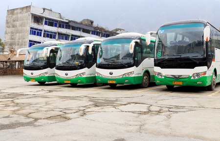 LIXIAN,CHINA -JAN 3,2015:row of green travel bus stop on the roadside.のeditorial素材