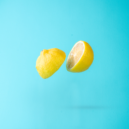 Cut yellow lemon on blue backgroundの写真素材