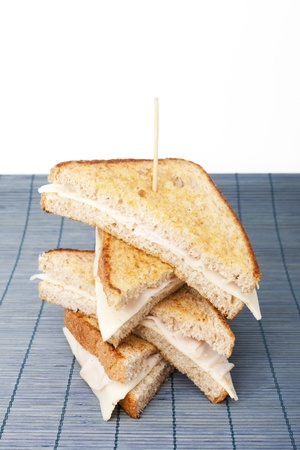 Stacking sandwiches of smoked turkey ham with cheeseの写真素材