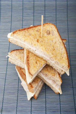 Stacking sandwiches of smoked turkey ham with cheeseの写真素材