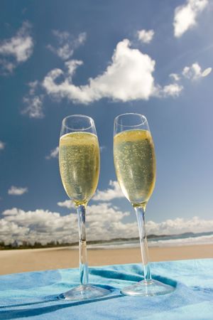 Two glasses of champagne over blue sky の写真素材