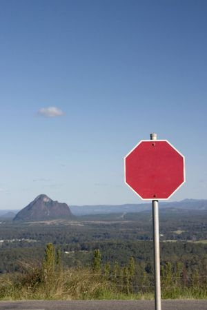 Blank road sign with mountains scenery at the backgroundの写真素材