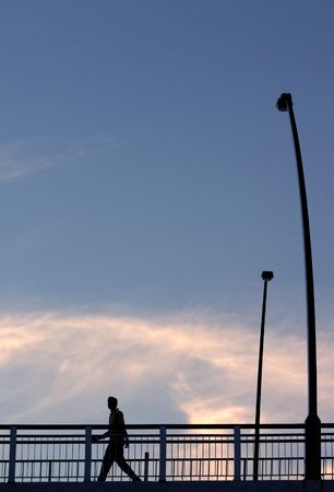 Silhouette of man on bridgeの写真素材