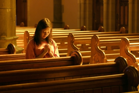 Woman praying at churchのeditorial素材