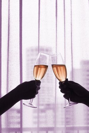 Champagne/Red Wine Toast with office buildings backgroundの写真素材