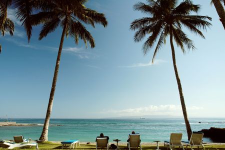 Tourists relaxing at a beautiful beachの写真素材