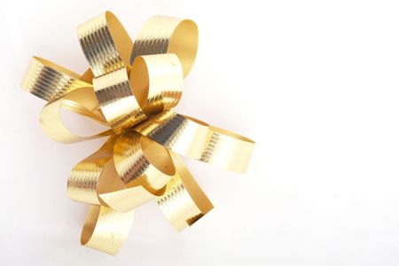 Gold ribbons for Christmas present over white backgroundの写真素材