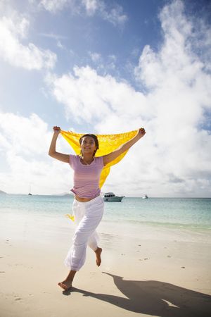 Asian woman running on beautiful whitehaven beach, Queensland, Australiaの写真素材