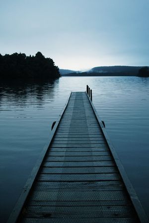 Old Pier captured while driving in New Zealand during sunsetの写真素材