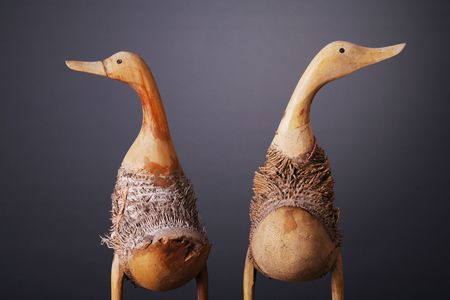 Wooden ducks shot over gray backgroundの写真素材