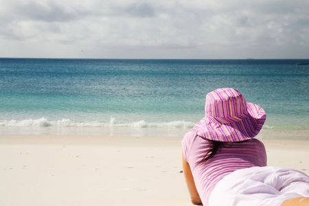 A woman relaxing on the beach in Whitsunday islandの写真素材