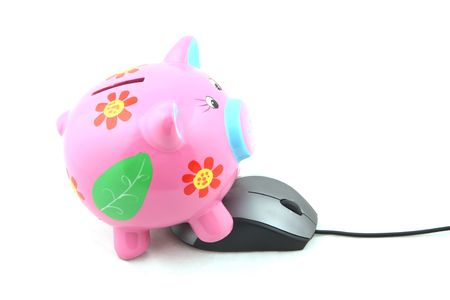 Isolated computer mouse and Piggy bank shot over white background.の写真素材