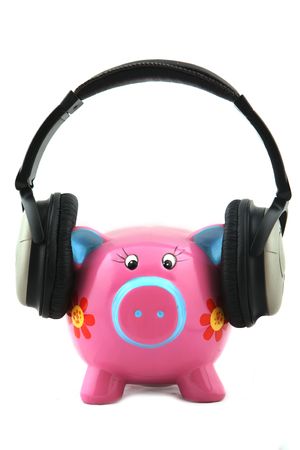 Isolated Piggy bank with headphone shot over white background.の写真素材