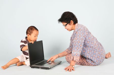 Learn how to use a laptop computer with grandmaの写真素材