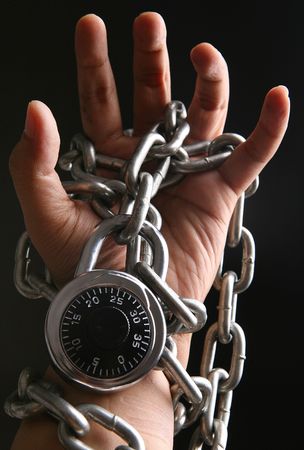 A hand locked with chain and combination lock