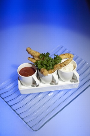 Chicken finger shot with tomato sauce and mayonnaiseの写真素材