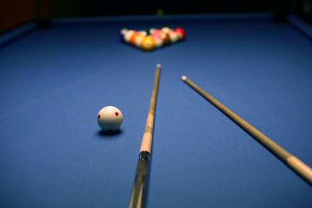 Billiard blue table with balsl and cues in beginning position.の写真素材