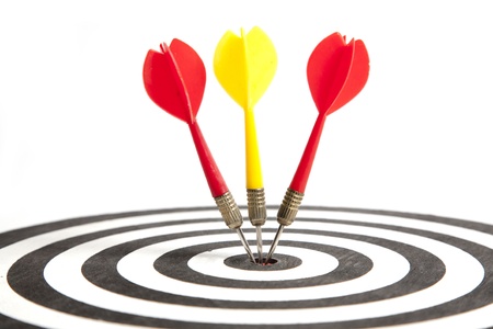 Three Darts hitting the middle of dartboard